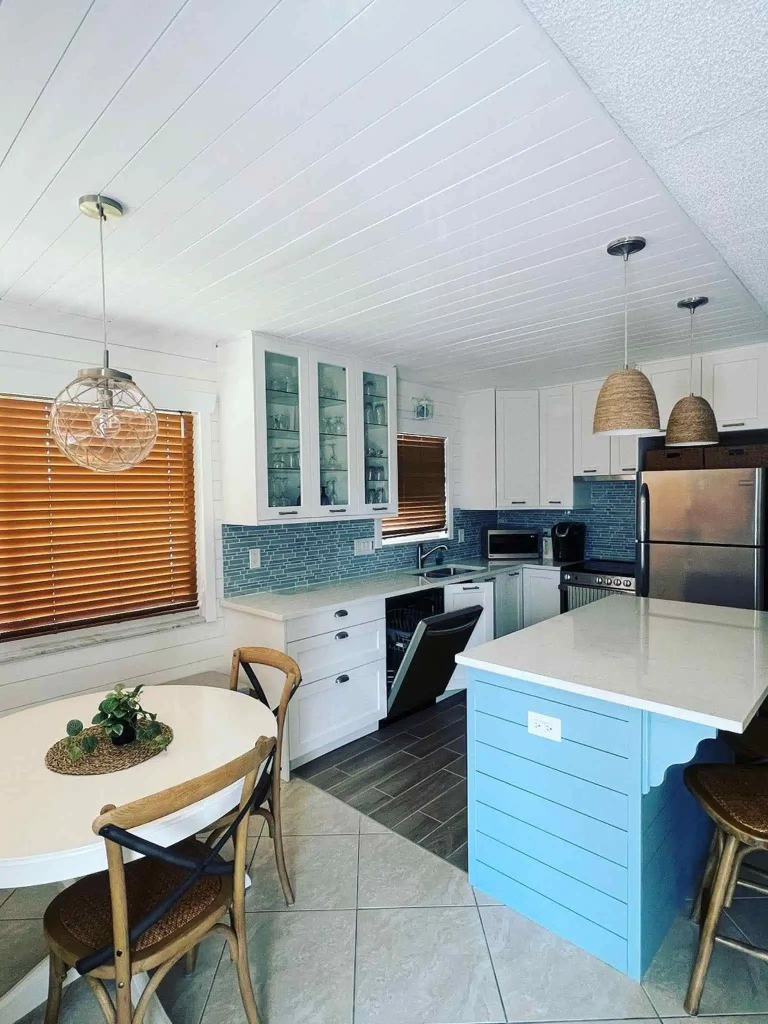 Minimalist pendant light fixtures illuminating a warm-toned residential space – professional home lighting service.