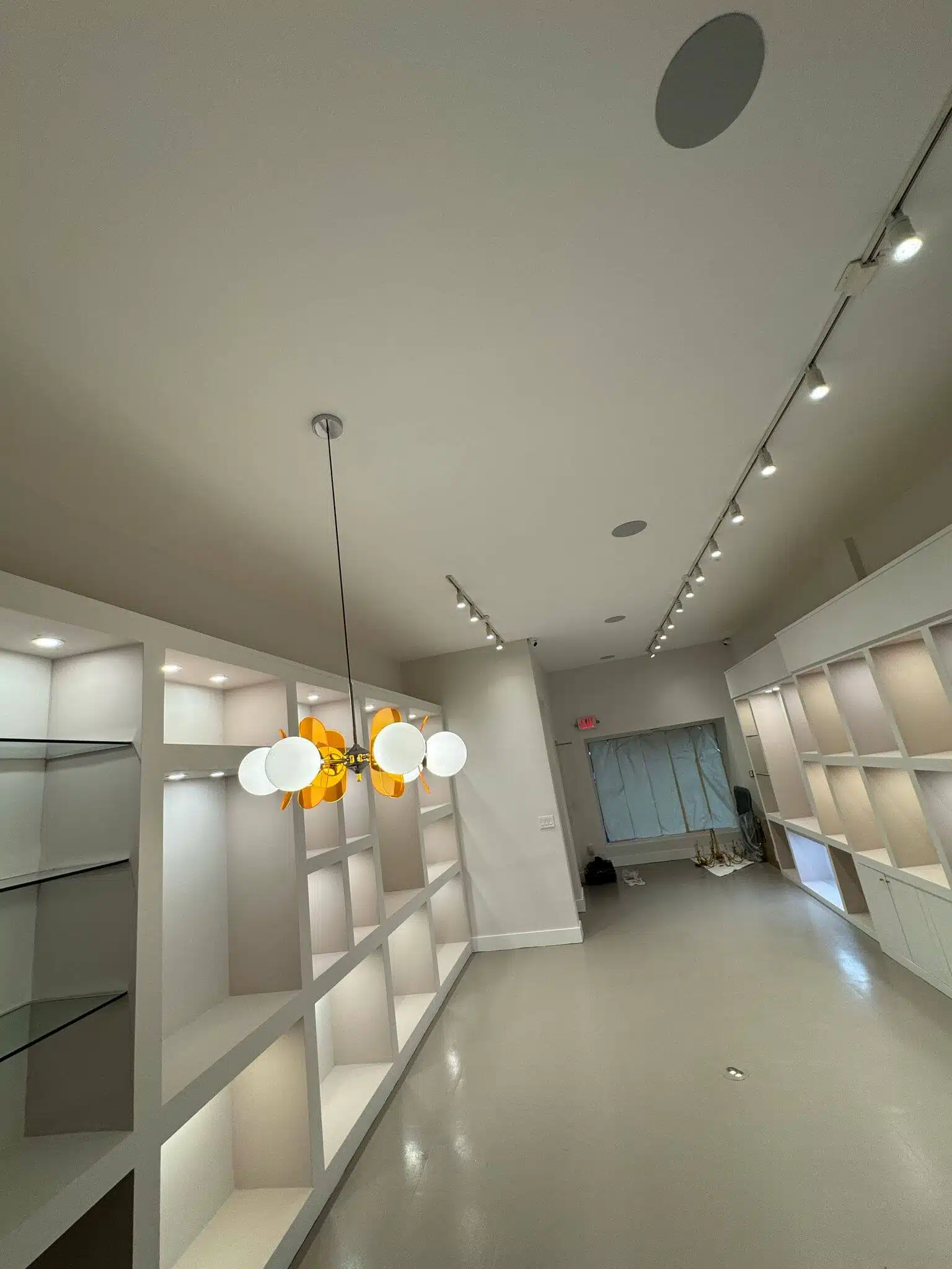 Decorative chandelier with exposed bulbs hanging above a dining table – part of electrical lighting enhancements for residential clients.