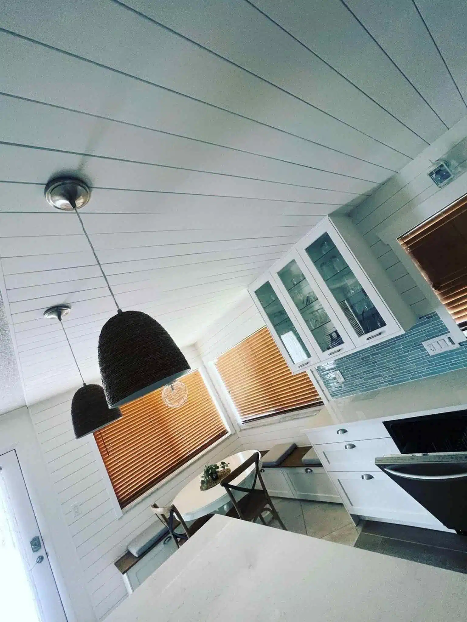 Multi-light bulb pendant chandelier hanging over a kitchen island – stylish and functional electrical upgrade.