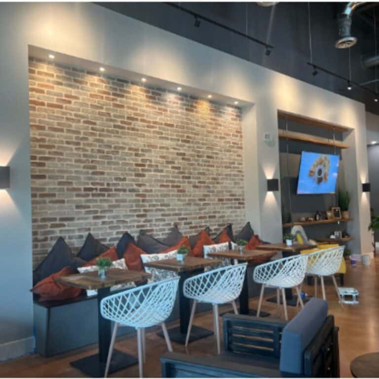 Cozy café with accent wall and custom lighting installation by Xmart Power Electric in South Florida.