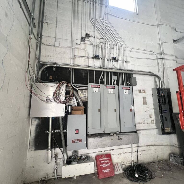 Organized commercial electrical panels with EMT conduit system installed by Xmart Power Electric in Florida.