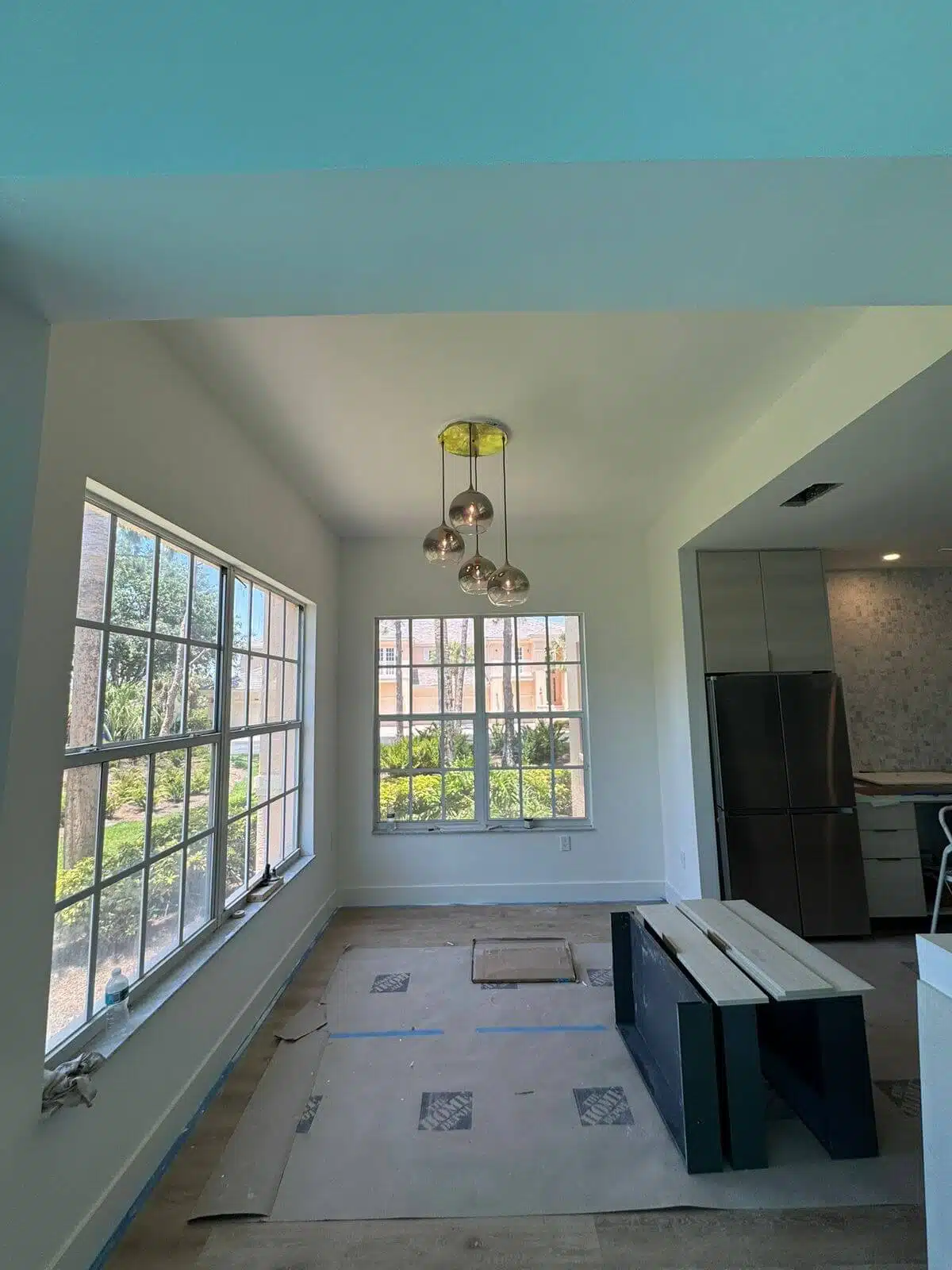 Combination of pendant and track lights illuminating a residential area – example of a complete home lighting solution.