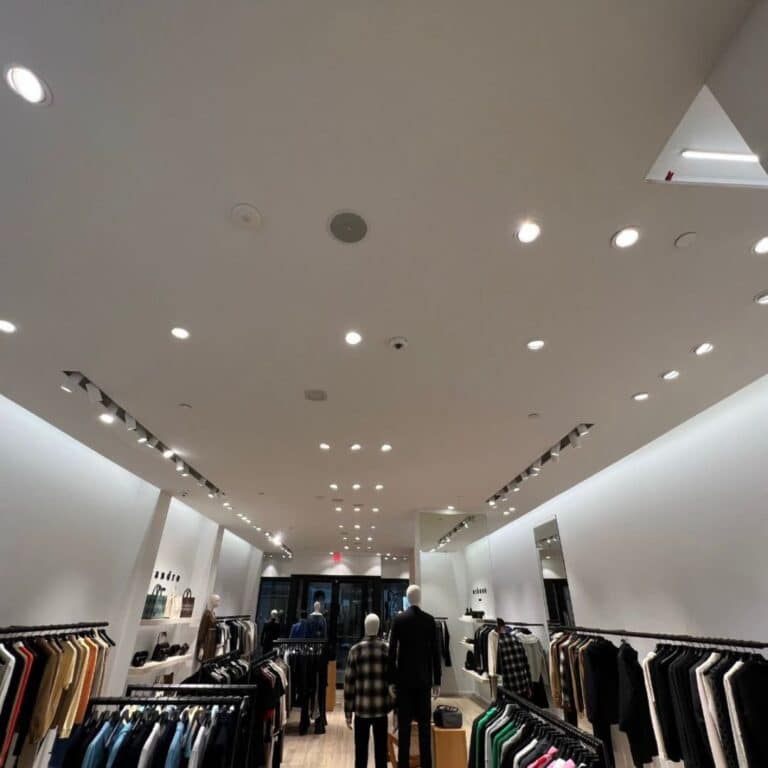 Modern retail clothing store with recessed and track lighting installed by Xmart Power Electric in Florida.