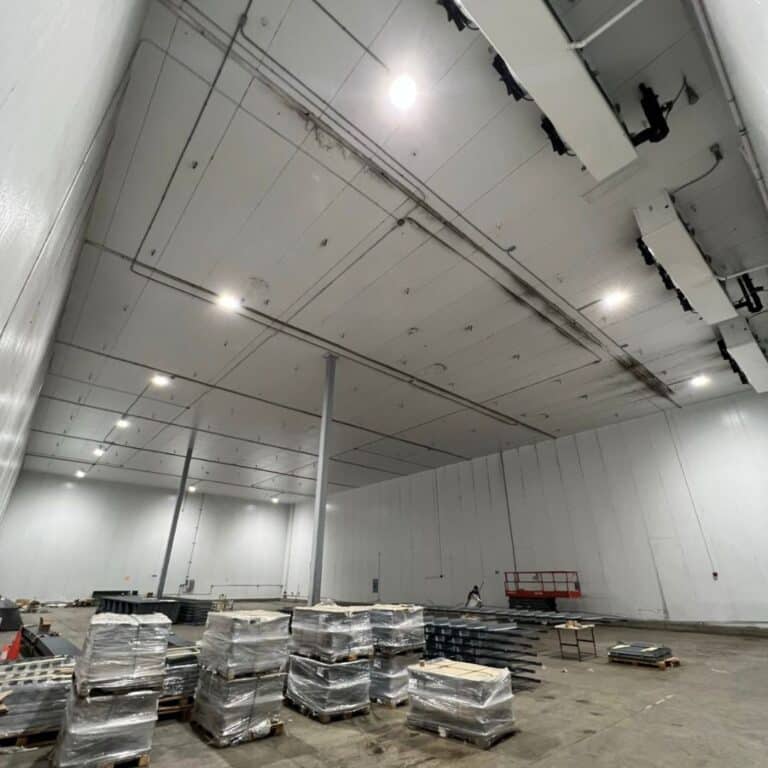 Wide industrial warehouse with LED ceiling lighting installed by commercial electricians in Florida.