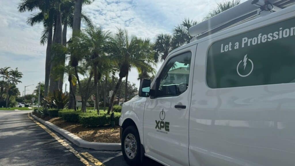 XPE Xmart Power Electric professional service van parked in a residential neighborhood for on-site electrical work.