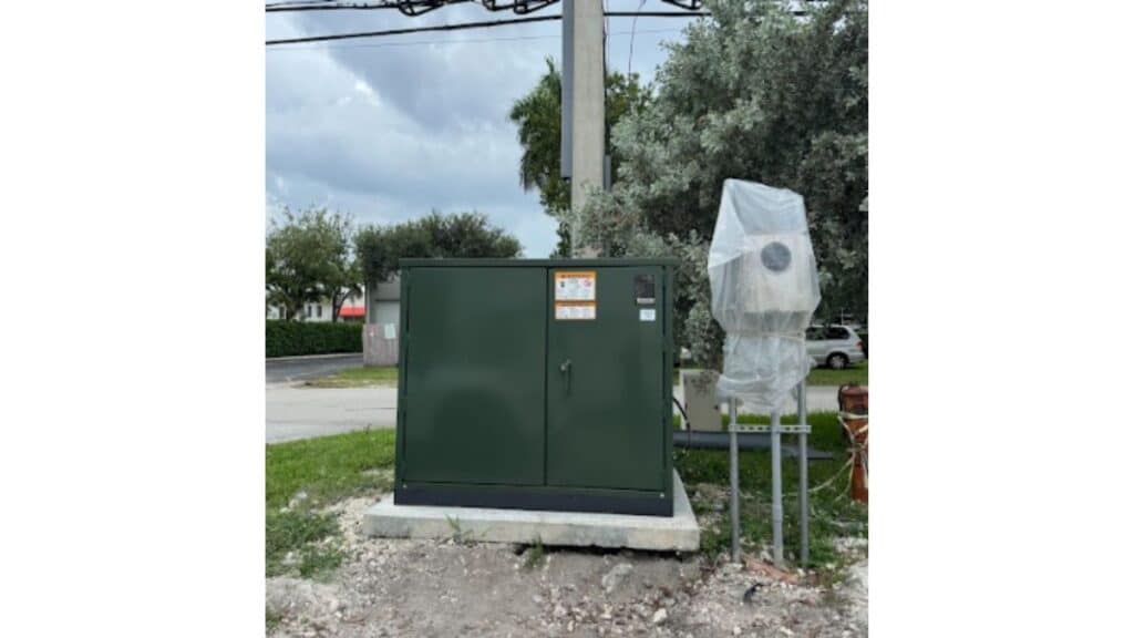 Outdoor electrical pad-mounted transformer and utility box installation.