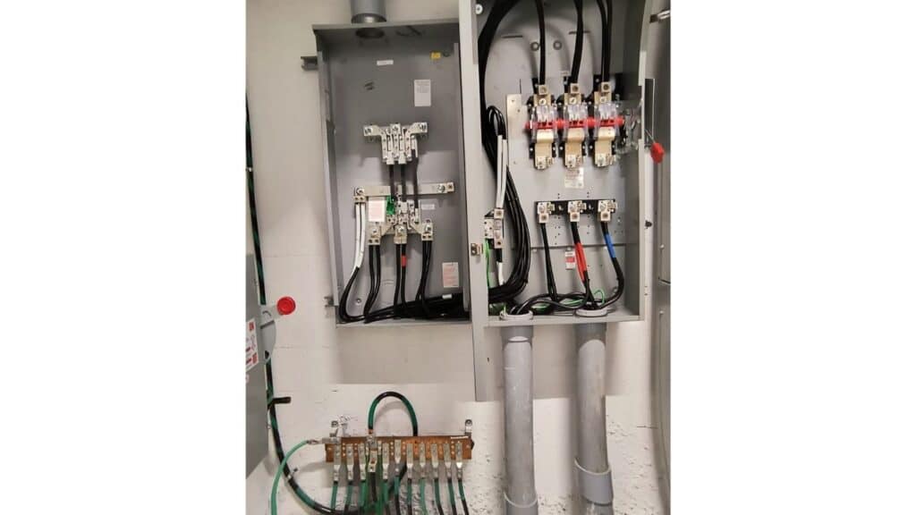 Commercial electrical panel wiring with heavy-duty conductors and grounding bar installation.