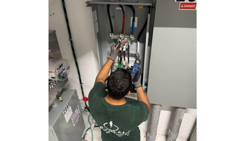 Professional electrician using a digital multimeter to test voltage in a commercial electrical disconnect panel for safety compliance.