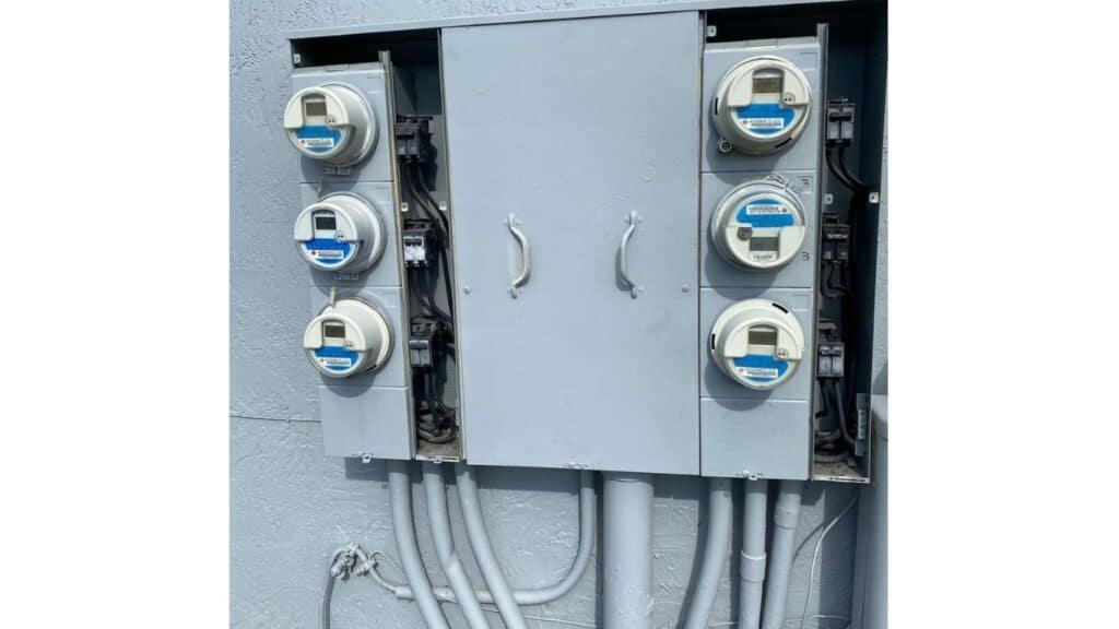 Multi-unit electrical meter bank installation with main service disconnects for a commercial building.